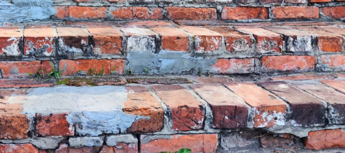 broken down brick steps@3x Broken brick steps with cracked mortar needing masonry repair
